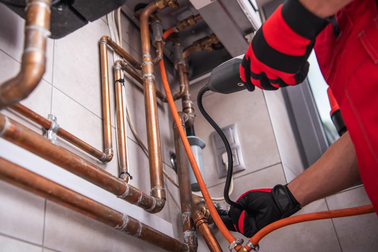 Licensed plumber checking pipework during a healthy home plumbing inspection
