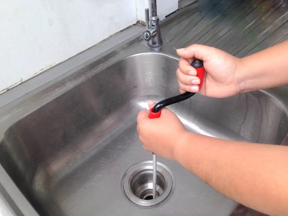 Plunging a blocked sink waste that is draining slowly